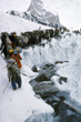 Line of porters queuing to cross glacial stream, Jim Duff, Australia