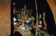 Two porters cooking in woven bamboo shelter, Tim McCartney-Snape, Australia
